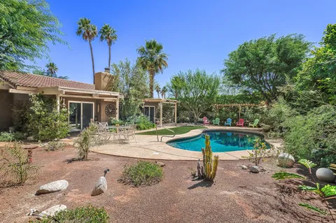 a view of a house with backyard porch and sitting area
