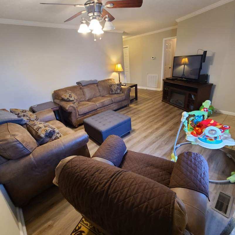 1749 Carney Winters Road Ashland City, TN 37015 - Photo 3 of 27 a living room with furniture a flat screen tv and a chandelier