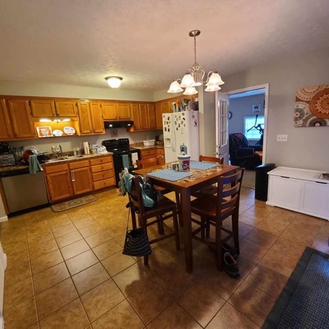 1749 Carney Winters Road Ashland City, TN 37015 - Photo 7 of 27 a view of a dining room with furniture and chandelier