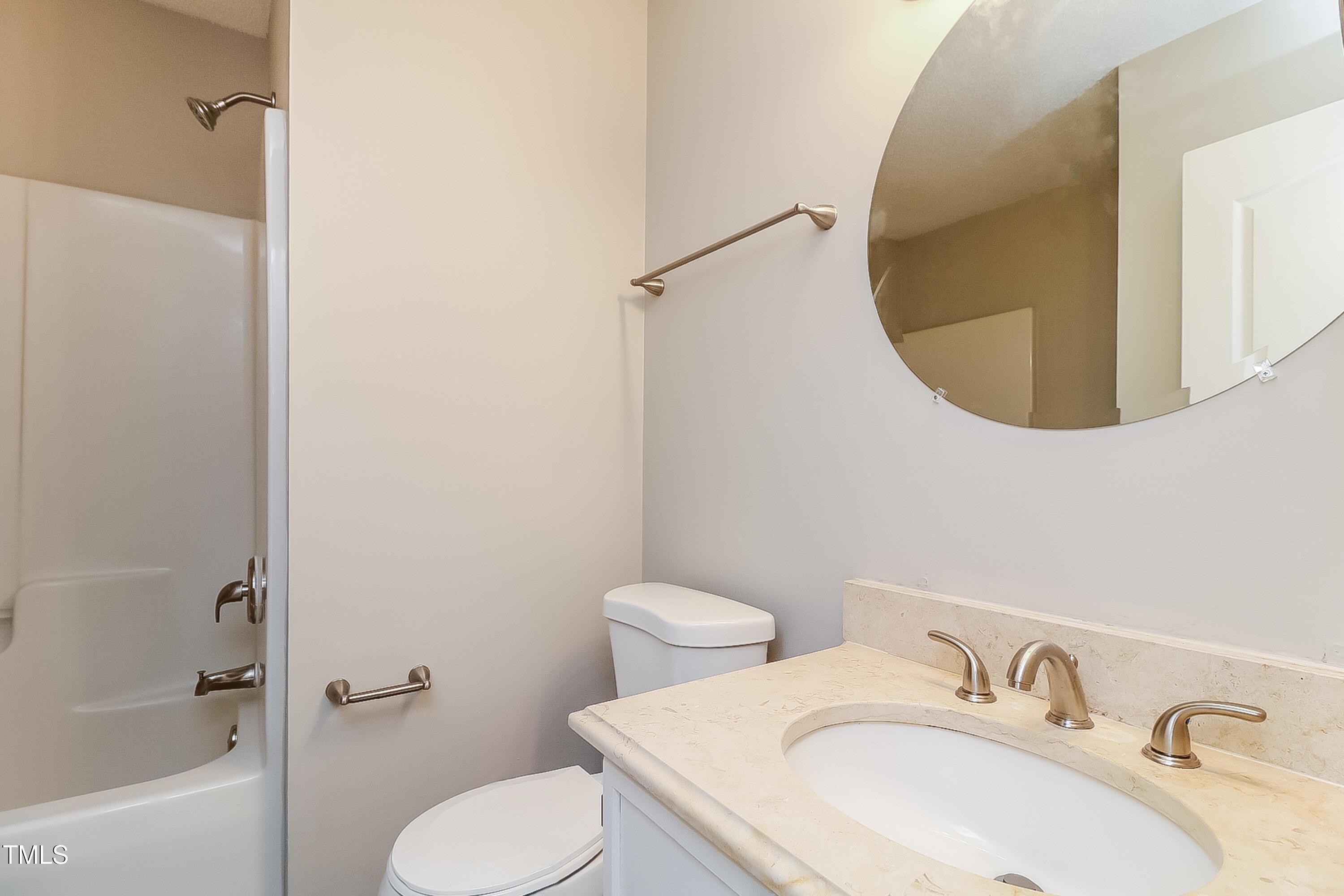 2933 Trassacks Drive Raleigh, NC 27610 - Photo 14 of 17 a bathroom with a sink mirror and toilet