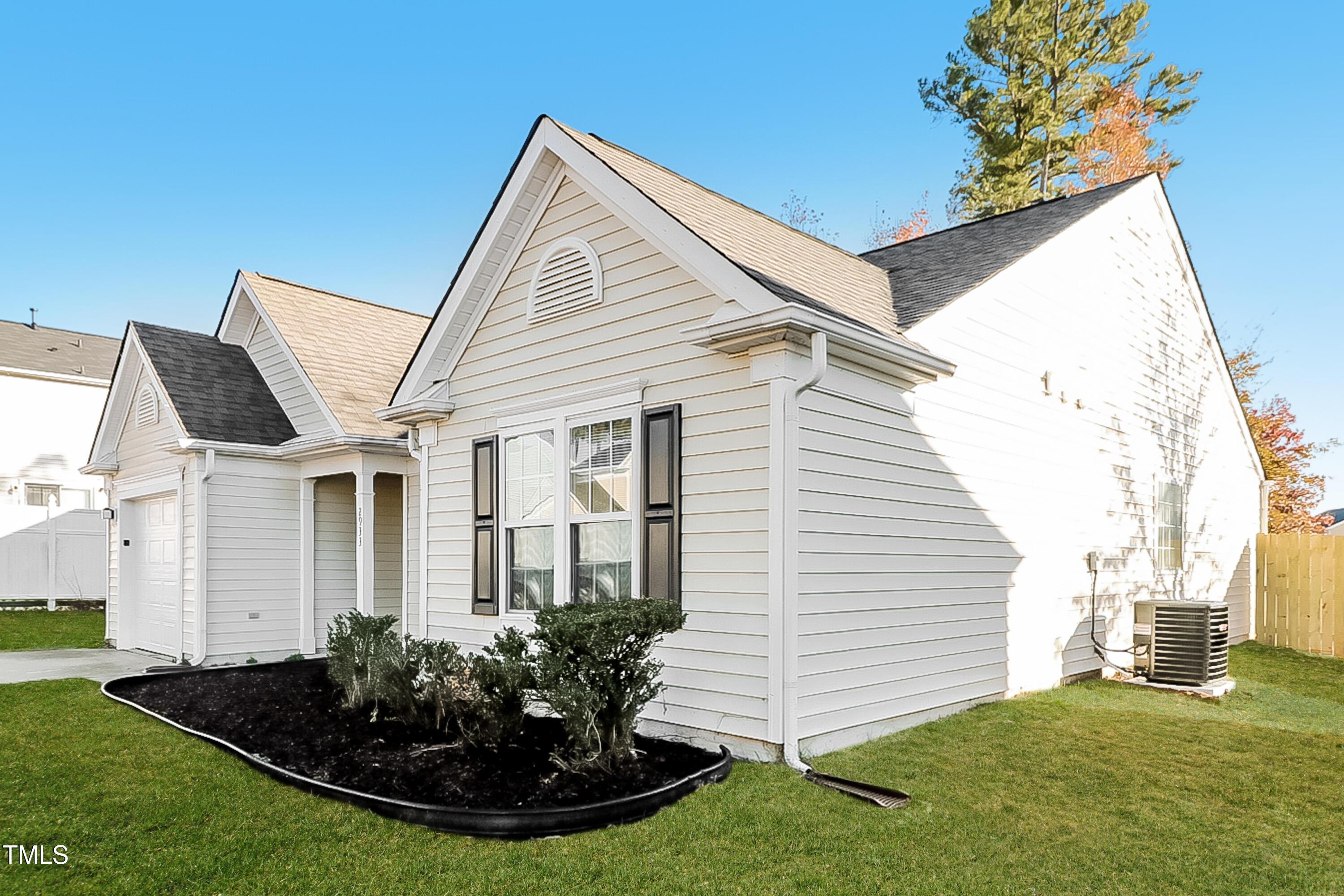 2933 Trassacks Drive Raleigh, NC 27610 - Photo 3 of 17 a view of a house with a yard and potted plants