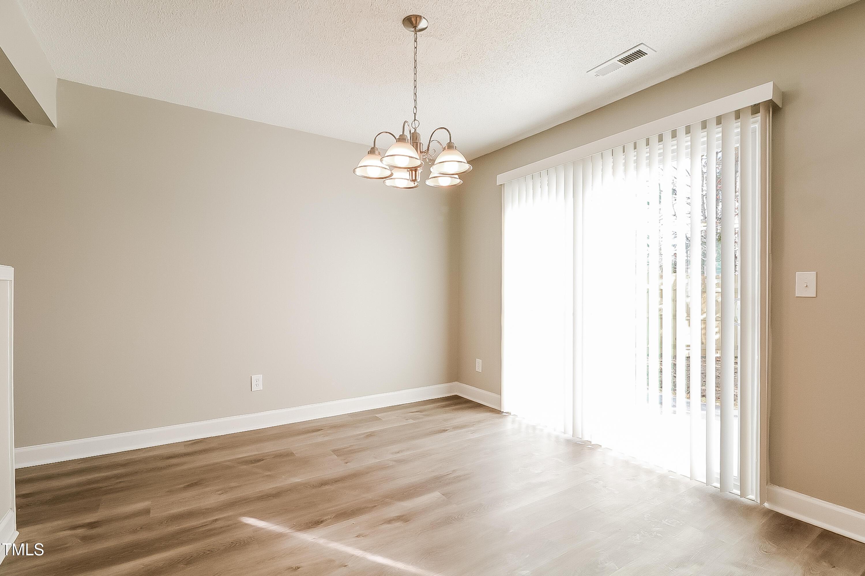 2933 Trassacks Drive Raleigh, NC 27610 - Photo 6 of 17 a view of a chandelier in a room