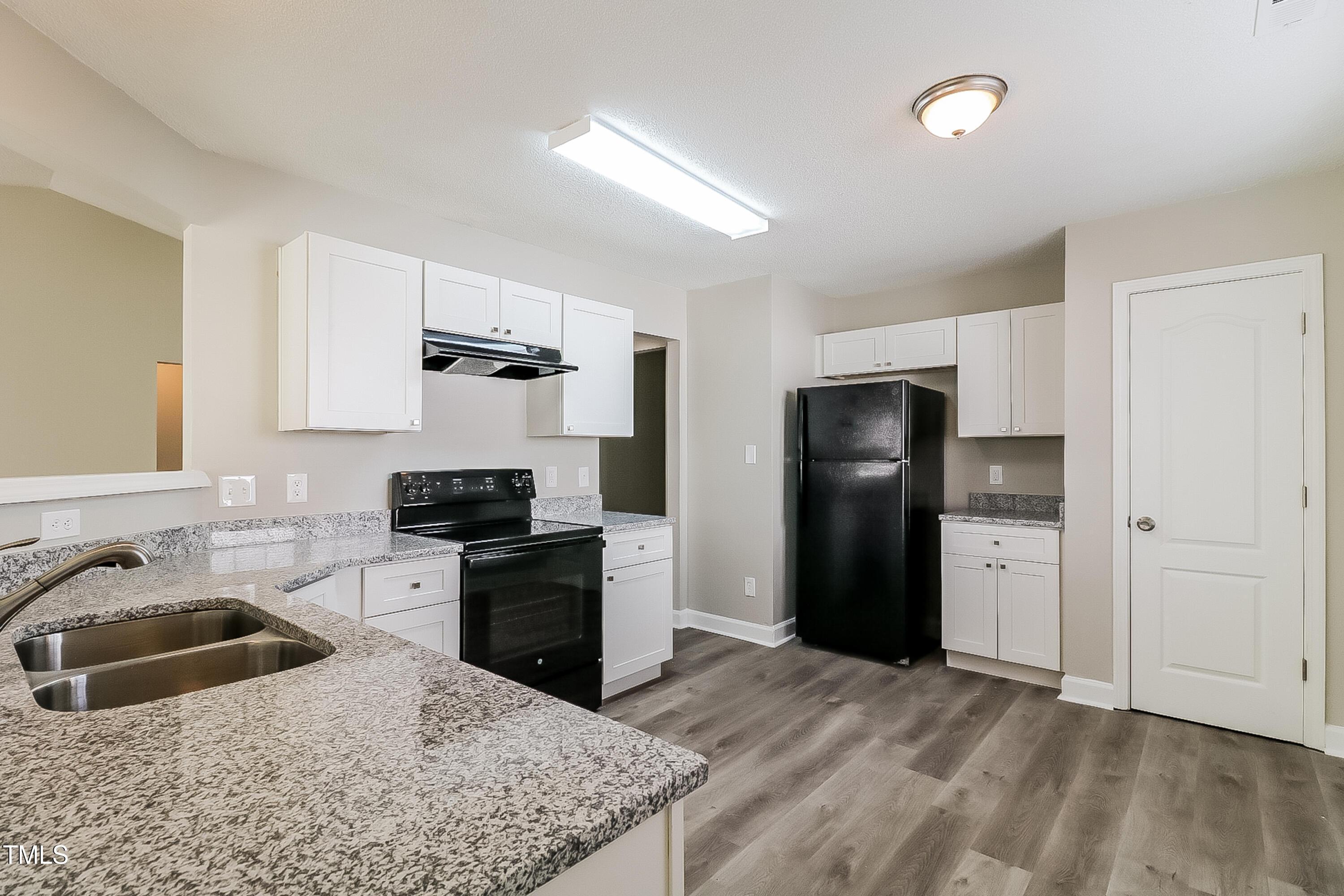 2933 Trassacks Drive Raleigh, NC 27610 - Photo 7 of 17 a kitchen with a refrigerator stove and sink