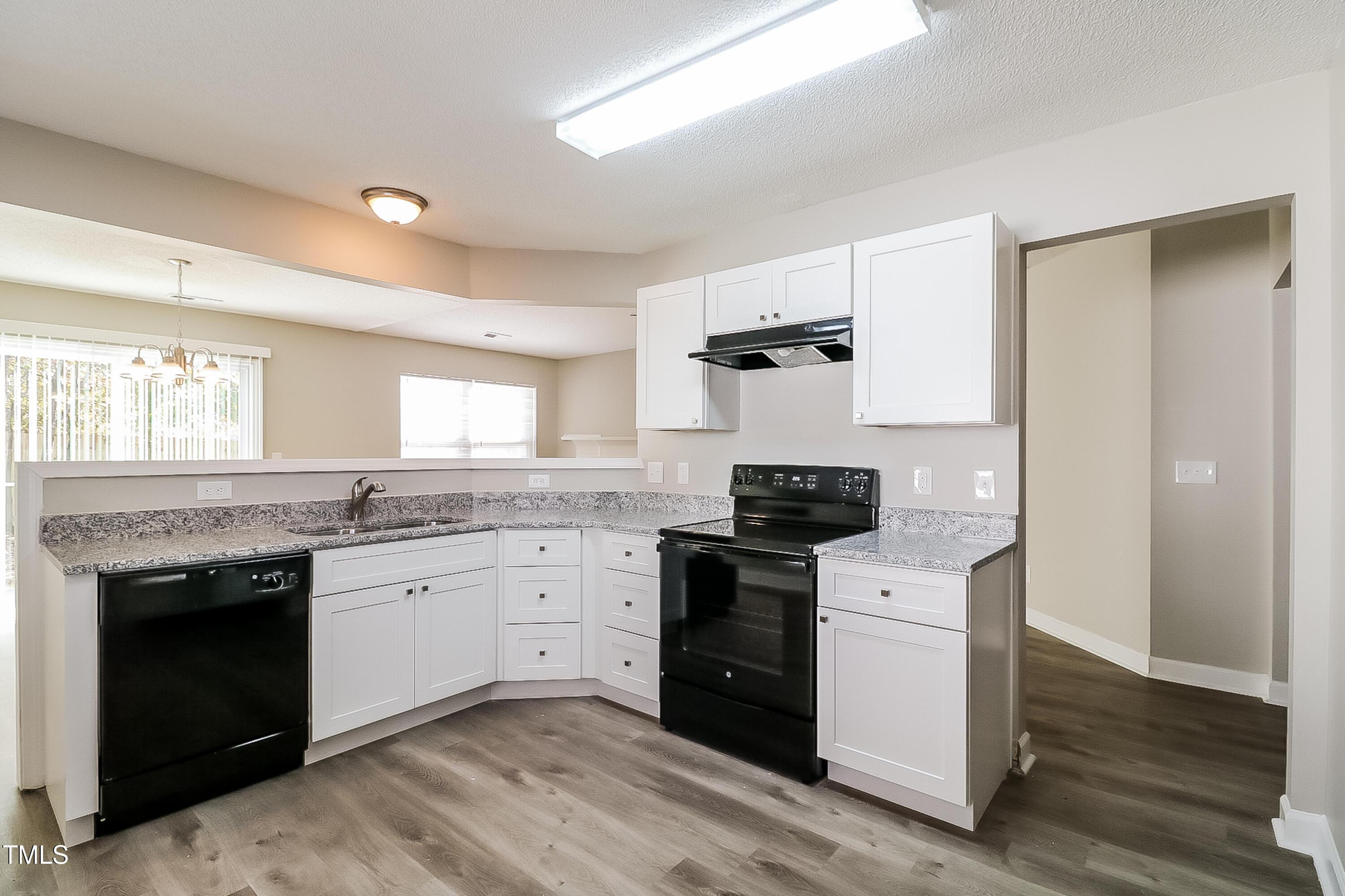 2933 Trassacks Drive Raleigh, NC 27610 - Photo 8 of 17 a kitchen with stainless steel appliances granite countertop a stove and a sink