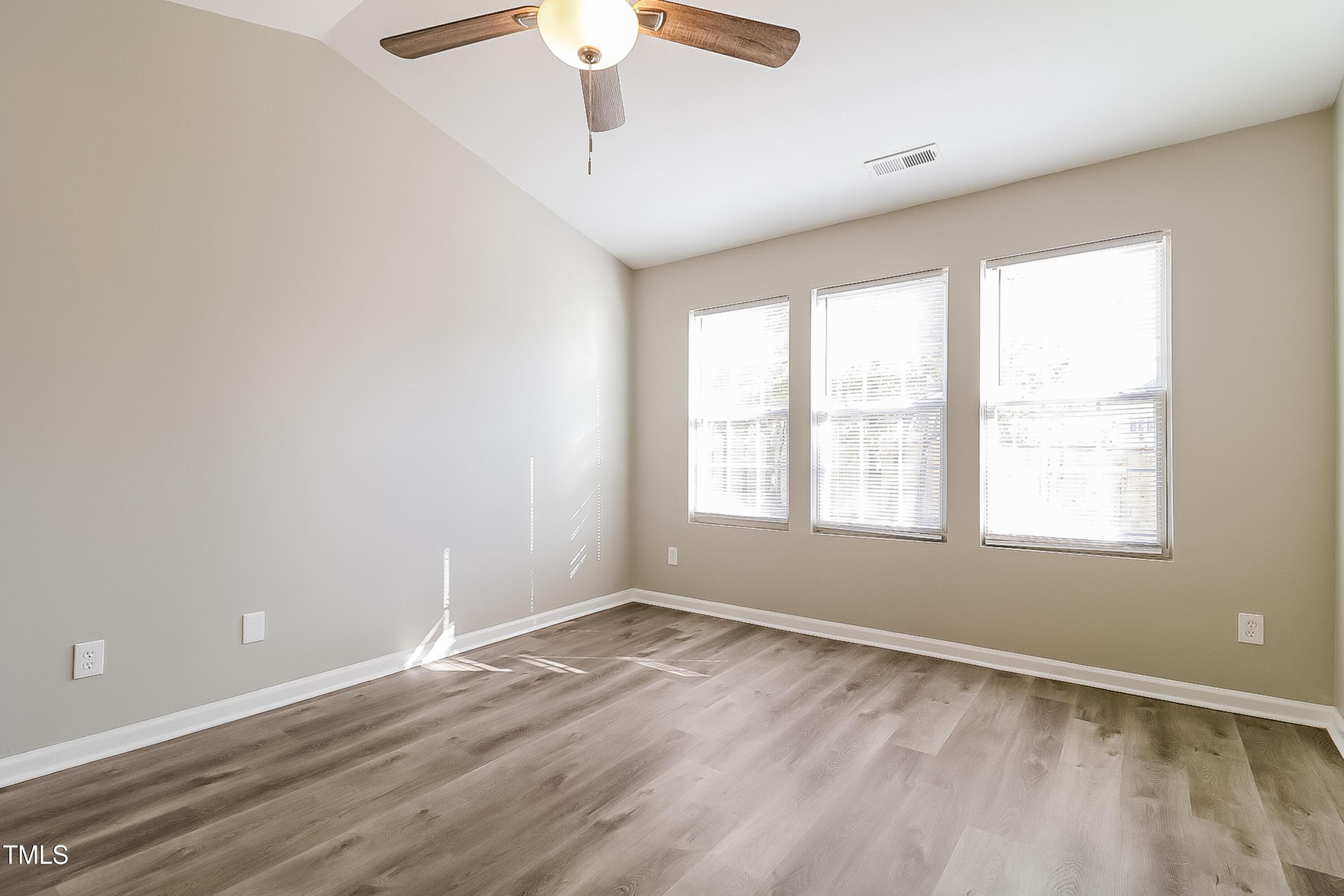 2933 Trassacks Drive Raleigh, NC 27610 - Photo 9 of 17 wooden floor in an empty room with a window