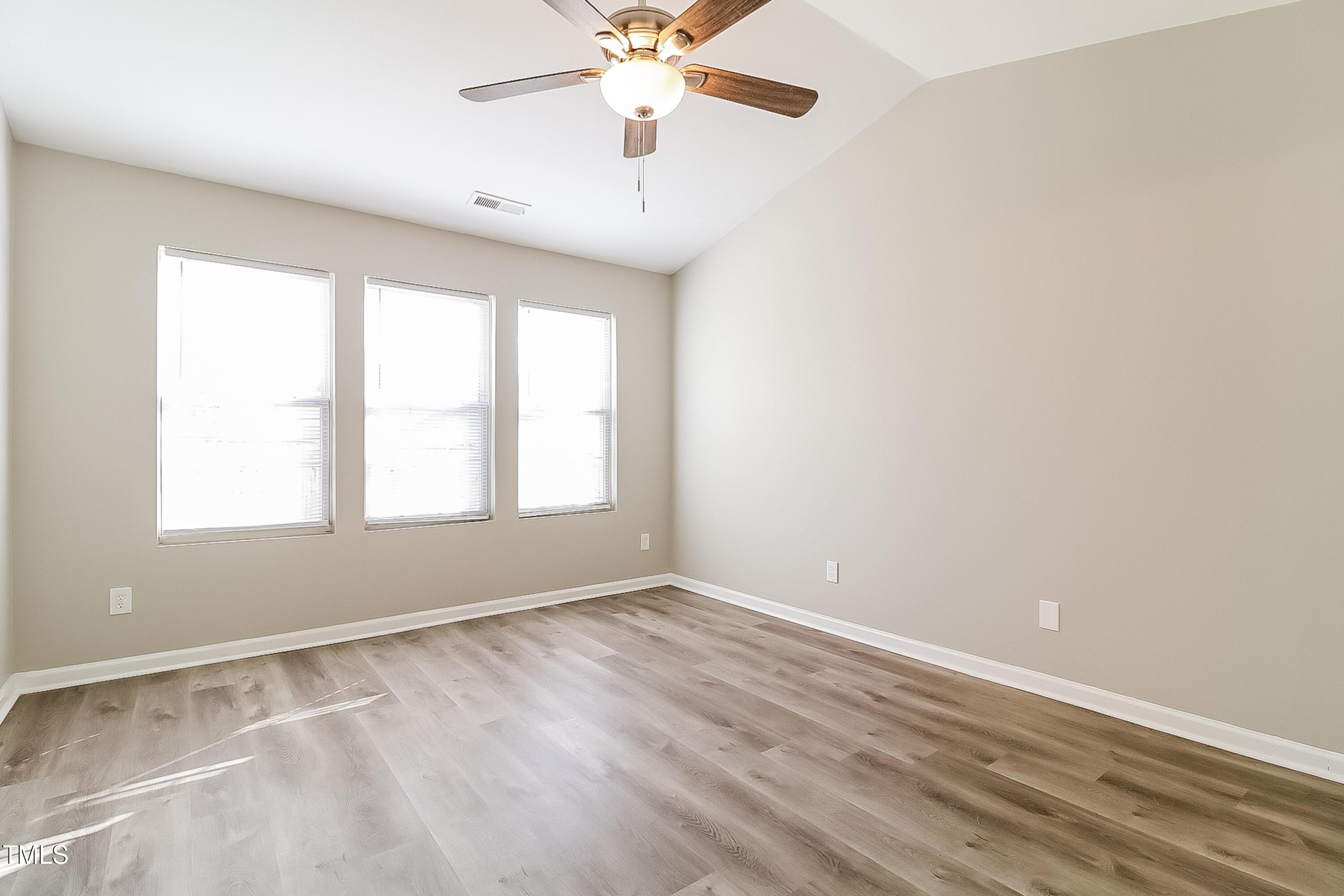 2933 Trassacks Drive Raleigh, NC 27610 - Photo 10 of 17 an empty room with windows and fan