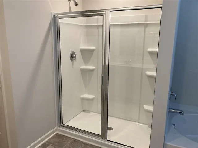 a bathroom with a glass shower door