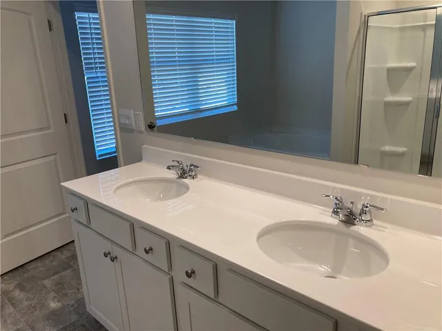 a bathroom with a sink and a large mirror