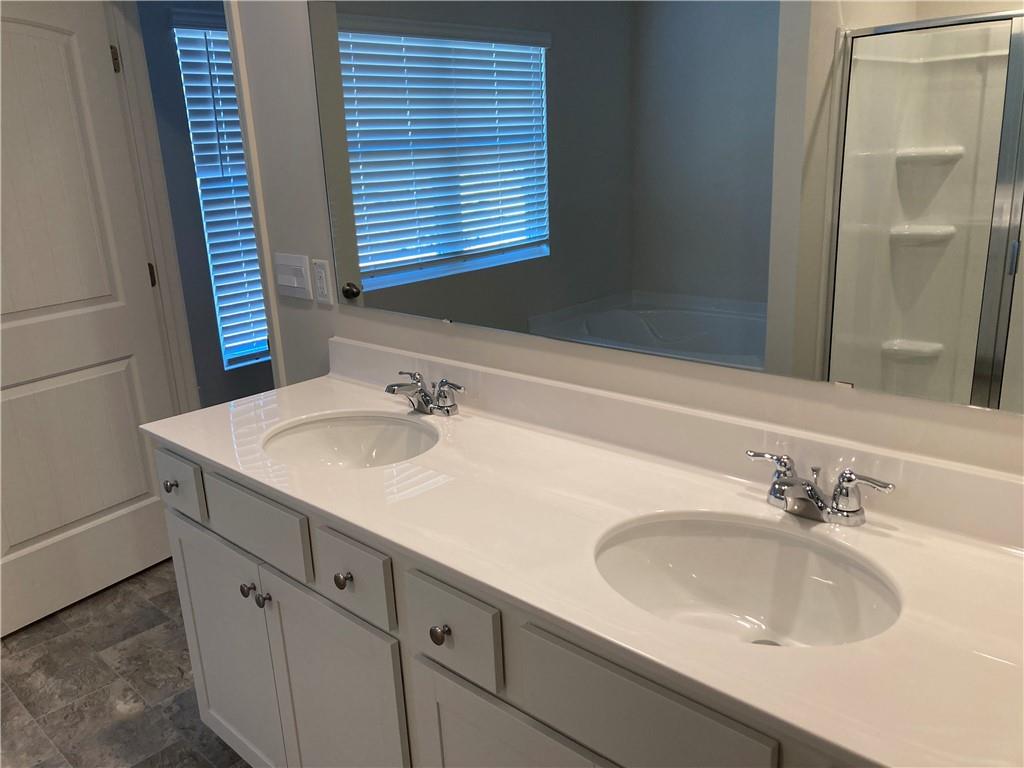 28 Rustin Ridge Dahlonega, GA 30533 - Photo 14 of 23 a bathroom with a sink and a large mirror