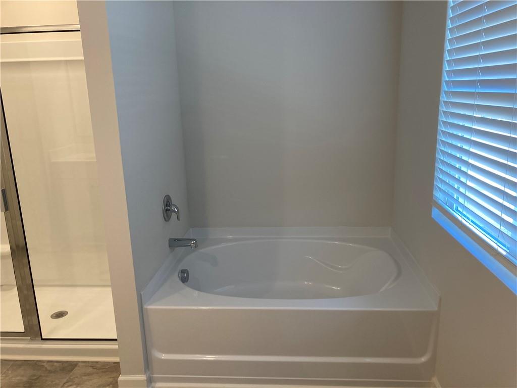 28 Rustin Ridge Dahlonega, GA 30533 - Photo 15 of 23 a white bath tub sitting next to a shower