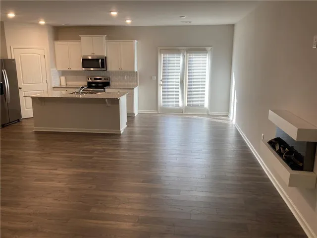 a kitchen with stainless steel appliances a refrigerator sink and microwave