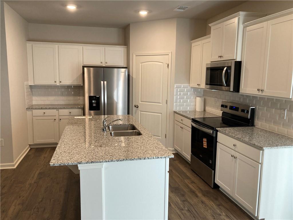28 Rustin Ridge Dahlonega, GA 30533 - Photo 4 of 23 a kitchen with stainless steel appliances granite countertop a refrigerator a stove and a sink