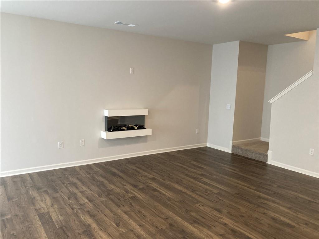28 Rustin Ridge Dahlonega, GA 30533 - Photo 8 of 23 a view of an empty room with wooden floor and a window