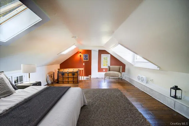 a bedroom with a large bed and a large window