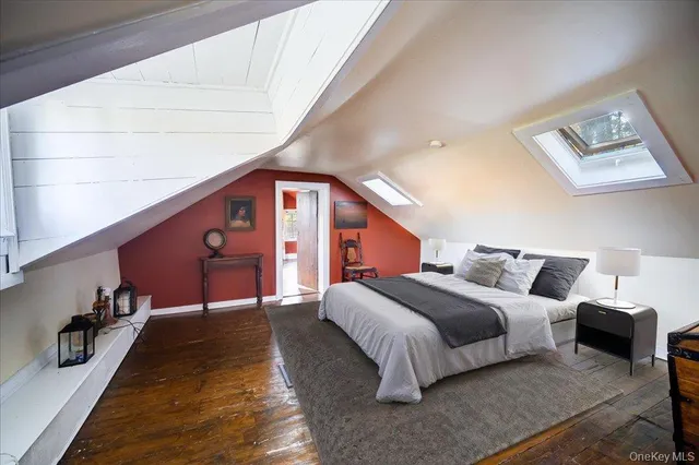 a bedroom with a bed and a night stand