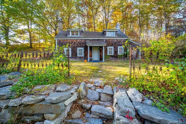 a front view of a house with swimming pool and sitting area