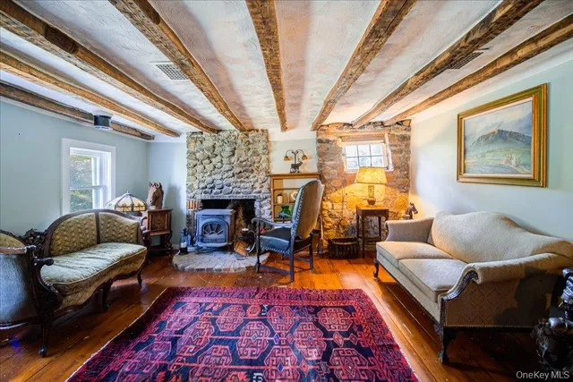 a living room with furniture fireplace and a table