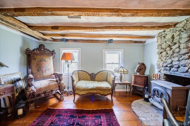 a living room with furniture a rug and a fireplace