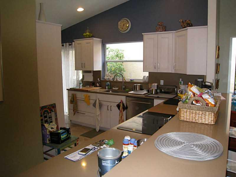 8075 Copenhagen Way Boca Raton, FL 33434 - Photo 8 of 24 a kitchen with a sink a stove and a microwave