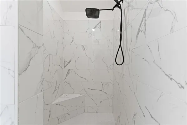 a bathroom with a glass shower door