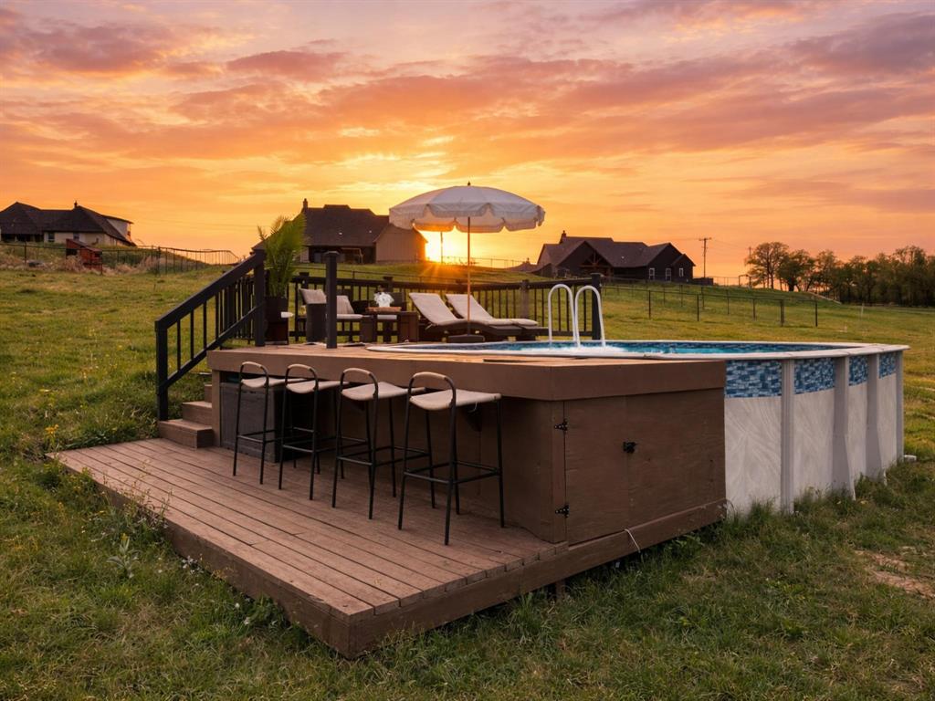 3021 Westfork Way Springtown, TX 76082 - Photo 31 of 35 a view of a roof deck with table and chairs a barbeque with wooden floor and fence