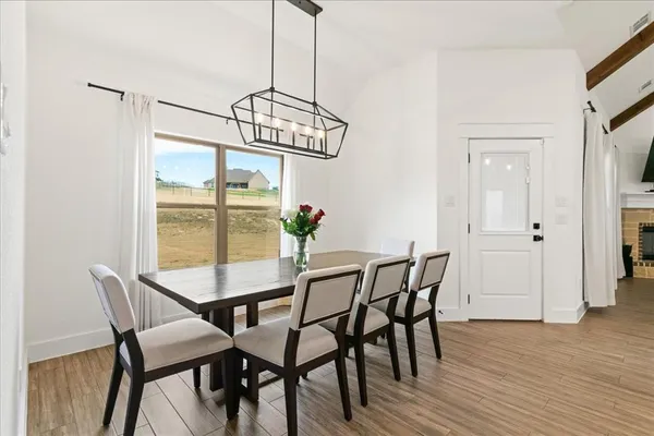 a view of a dining room with furniture window and wooden floor