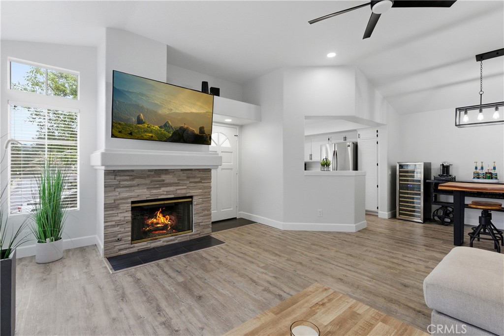 a living room with furniture a flat screen tv and a fireplace