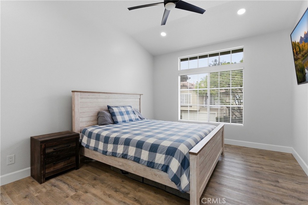 8070 East Oak Ridge Circle Anaheim Hills, CA 92808 - Photo 12 of 22 a bedroom with a bed lamp and a window