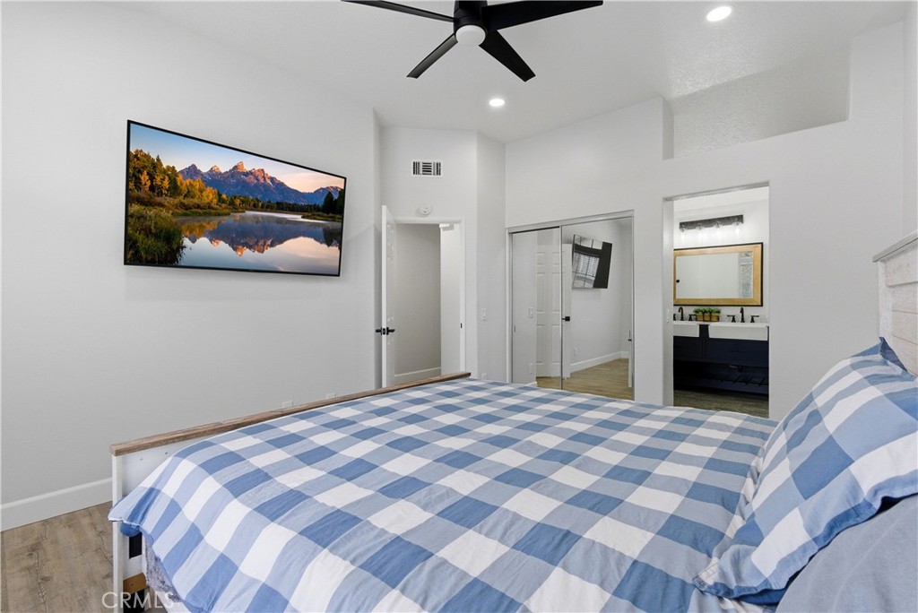 8070 East Oak Ridge Circle Anaheim Hills, CA 92808 - Photo 14 of 22 a bedroom with a large bed and a chandelier