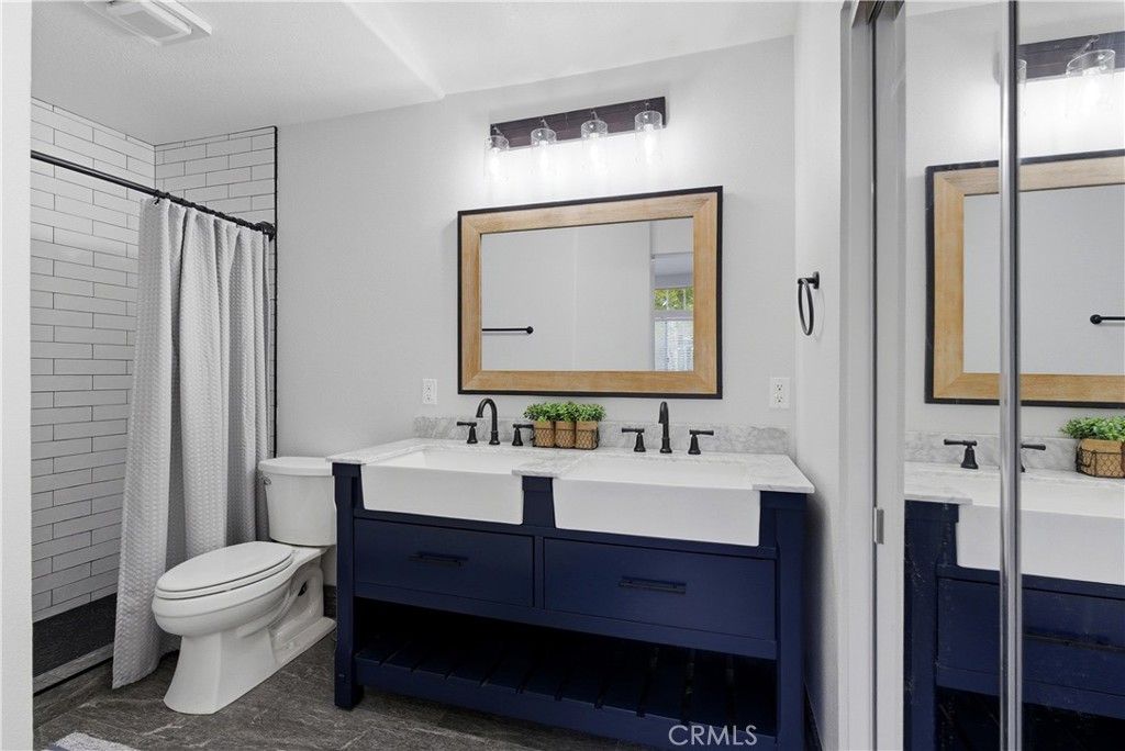 8070 East Oak Ridge Circle Anaheim Hills, CA 92808 - Photo 15 of 22 a bathroom with a toilet sink and mirror