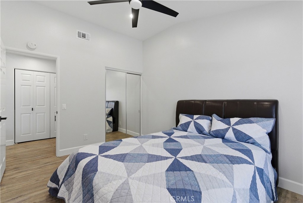 8070 East Oak Ridge Circle Anaheim Hills, CA 92808 - Photo 18 of 22 a bedroom with a bed and a mirror