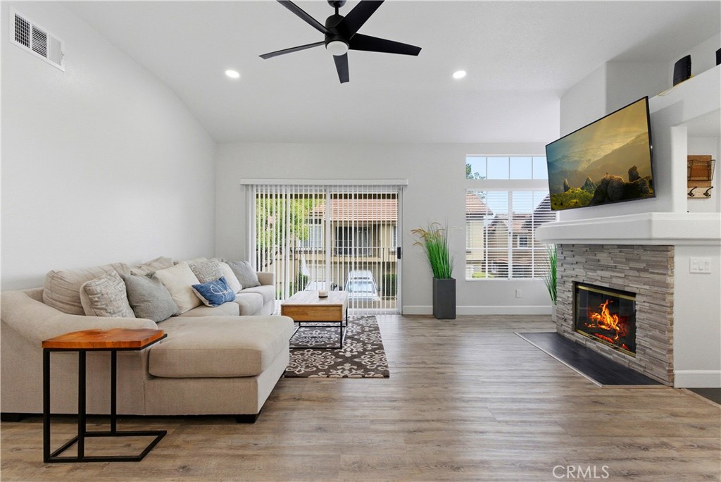 8070 East Oak Ridge Circle Anaheim Hills, CA 92808 - Photo 2 of 22 a living room with furniture fireplace and flat screen tv