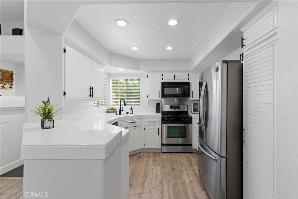 8070 East Oak Ridge Circle Anaheim Hills, CA 92808 - Photo 7 of 22 a kitchen with a refrigerator and a sink