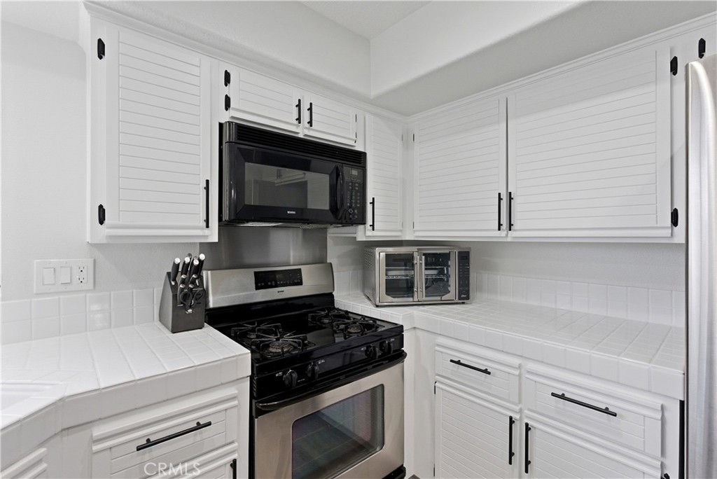 8070 East Oak Ridge Circle Anaheim Hills, CA 92808 - Photo 8 of 22 a kitchen with cabinets stainless steel appliances and a counter space