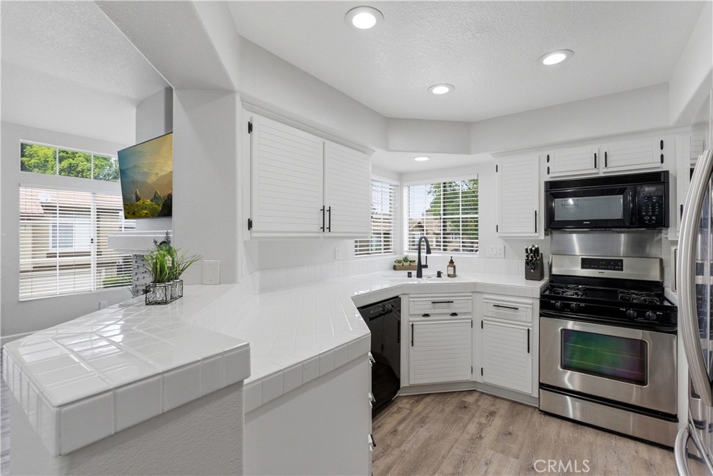 8070 East Oak Ridge Circle Anaheim Hills, CA 92808 - Photo 9 of 22 a kitchen with a sink stove and microwave