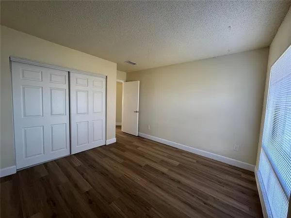a view of an empty room and wooden floor
