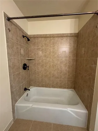 a bathroom with a shower and a bath tub