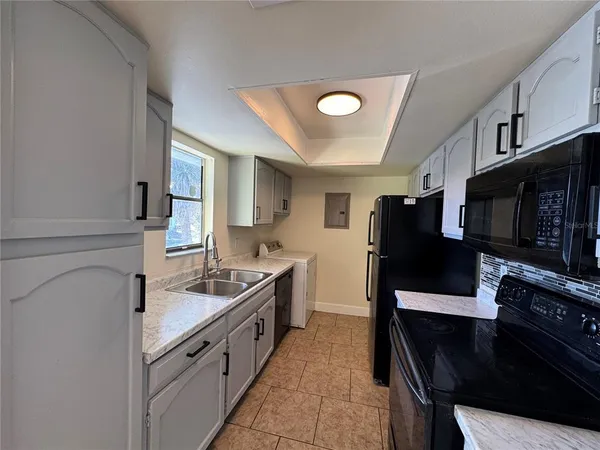 a kitchen with stainless steel appliances a stove microwave and a refrigerator