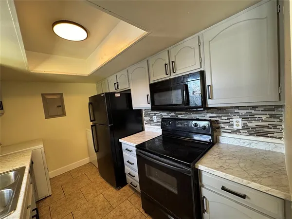 a kitchen with a stove microwave and refrigerator