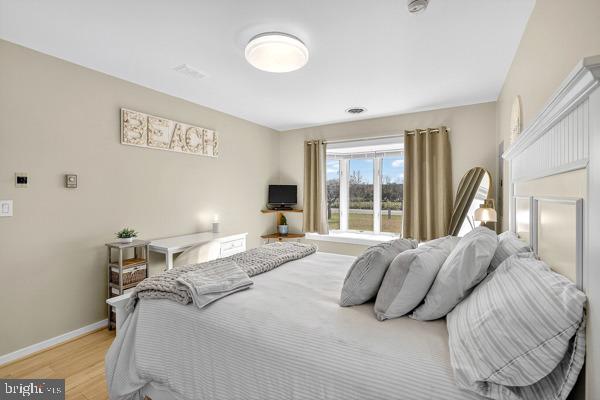 419 Williamsville Road Houston, DE 19954 - Photo 23 of 65 a bedroom with a bed and a large window