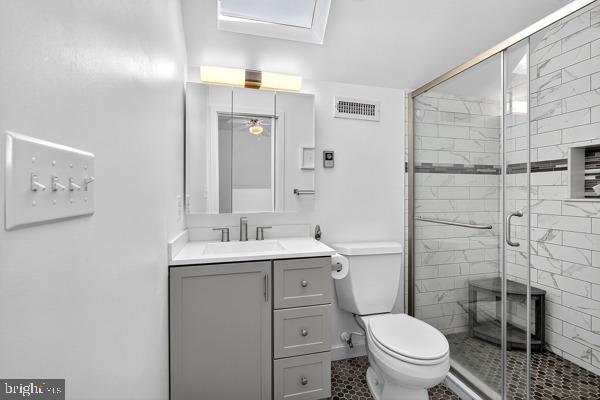 419 Williamsville Road Houston, DE 19954 - Photo 47 of 65 a bathroom with a granite countertop toilet sink and a shower