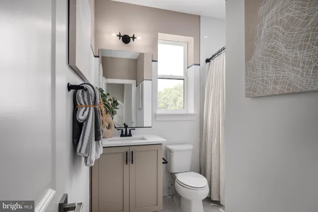 a bathroom with a toilet sink and mirror