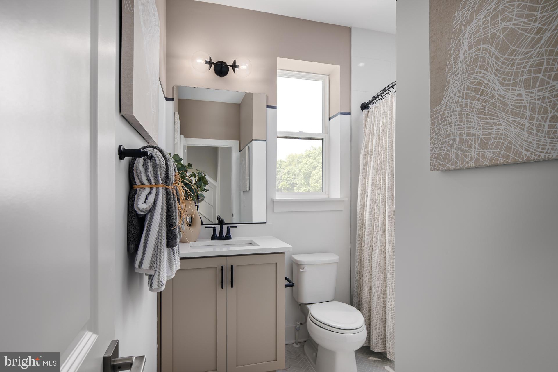 227 Light Street Baltimore, MD 21230 - Photo 13 of 29 a bathroom with a toilet sink and mirror