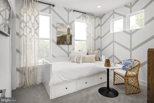 a bedroom with furniture and a window