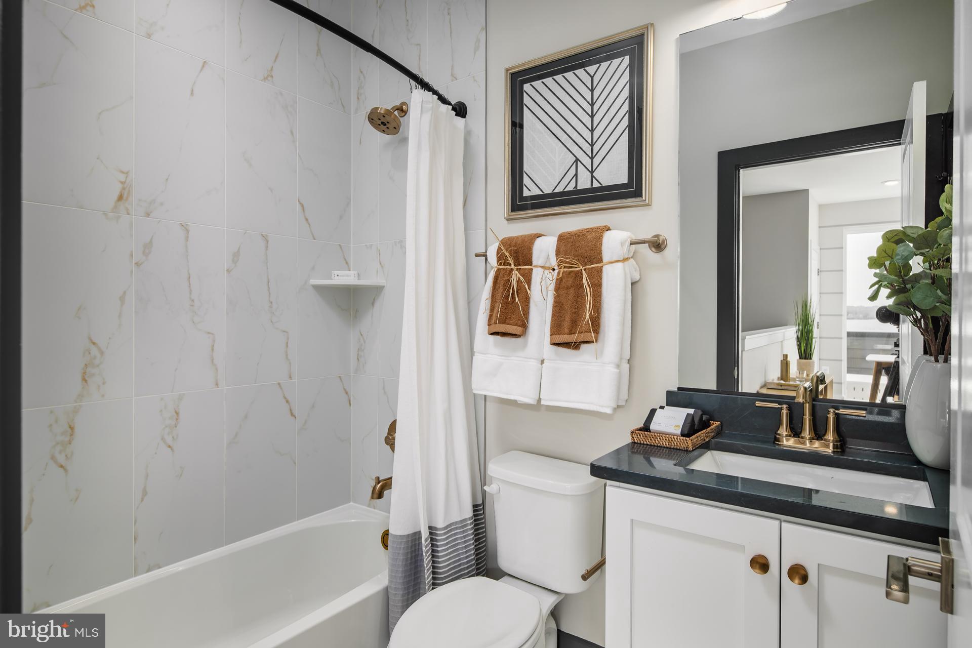 227 Light Street Baltimore, MD 21230 - Photo 16 of 29 a bathroom with a granite countertop sink toilet and shower