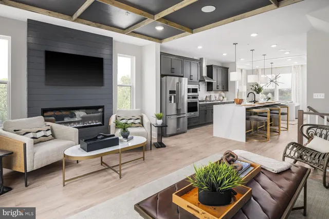 a living room with furniture kitchen view and a fireplace