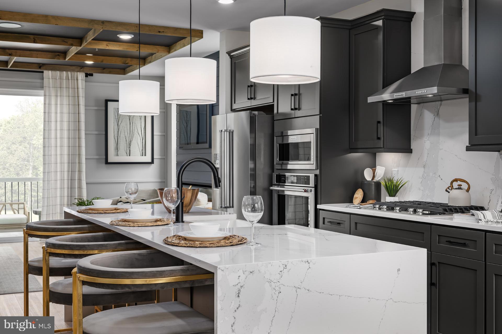 227 Light Street Baltimore, MD 21230 - Photo 4 of 29 a kitchen with sink a stove and chairs