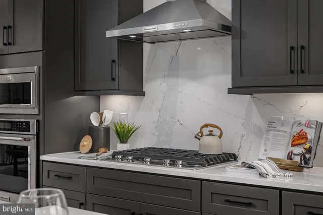a kitchen with stainless steel appliances granite countertop a sink and cabinets