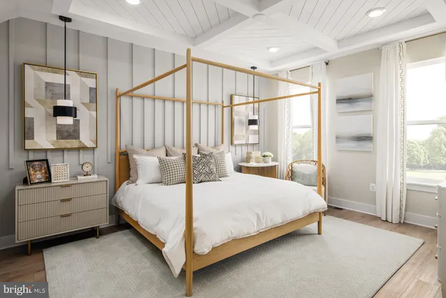 a bedroom with a large bed and a window