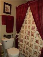 6771 Lovel Cook Road Springfield, TN 37172 - Photo 10 of 18 a white toilet sitting next to a shower curtain